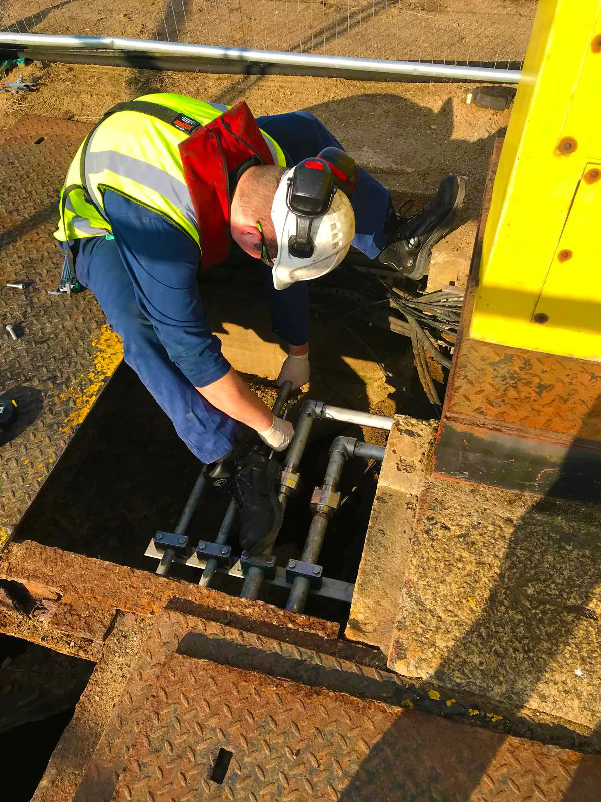 man on industrial site sorting out hydraulics